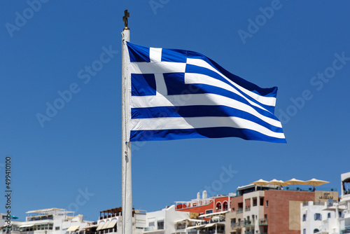 Greek flag on the blue sky background.