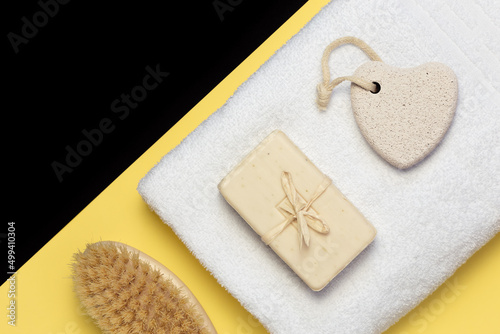 Personal hygiene items soap, pumice stone, brush, towel. Cosmetology, personal care and skin cleansing. Top view