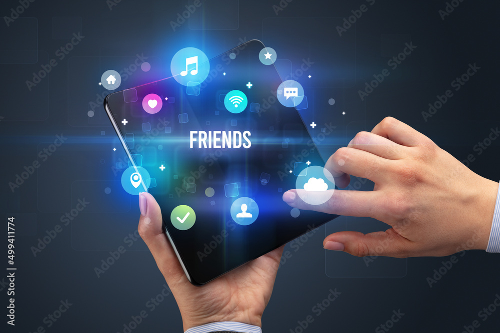 Businessman holding a foldable smartphone Businessman holding a foldable smartphone