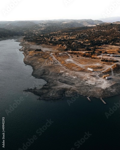 Aerial view of a village and container storage field near a lake  in Limassol, Cyprus.