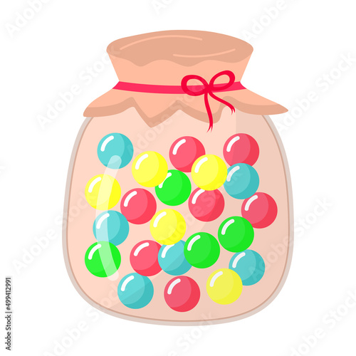 Glass jar with round sweet caramel lollipops.
