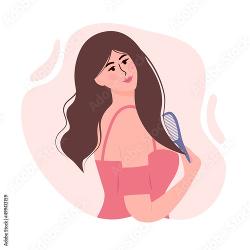 Beautiful woman is combing her hair. Hair care beauty concept and daily self care routine.