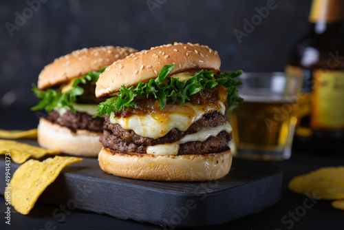 Big hamburger with cheese and green salad