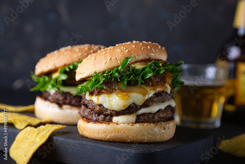 Big hamburger with cheese and green salad