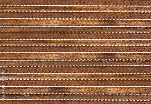 Metal rods with traces of rust are displayed in parallel