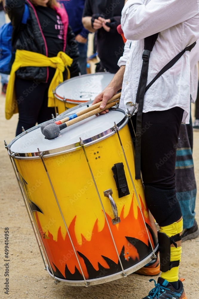 Drummers and musicians during the open-air parade at a popular festival in Badalona, Spain. Close-up detail