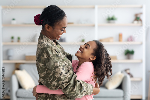 Vászonkép Loving black mother soldier bonding with her cute daughter