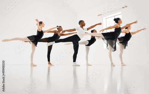 Dance, if youve torn the bandage off. Shot of a group of ballet dancers practicing a routine in a dance studio.
