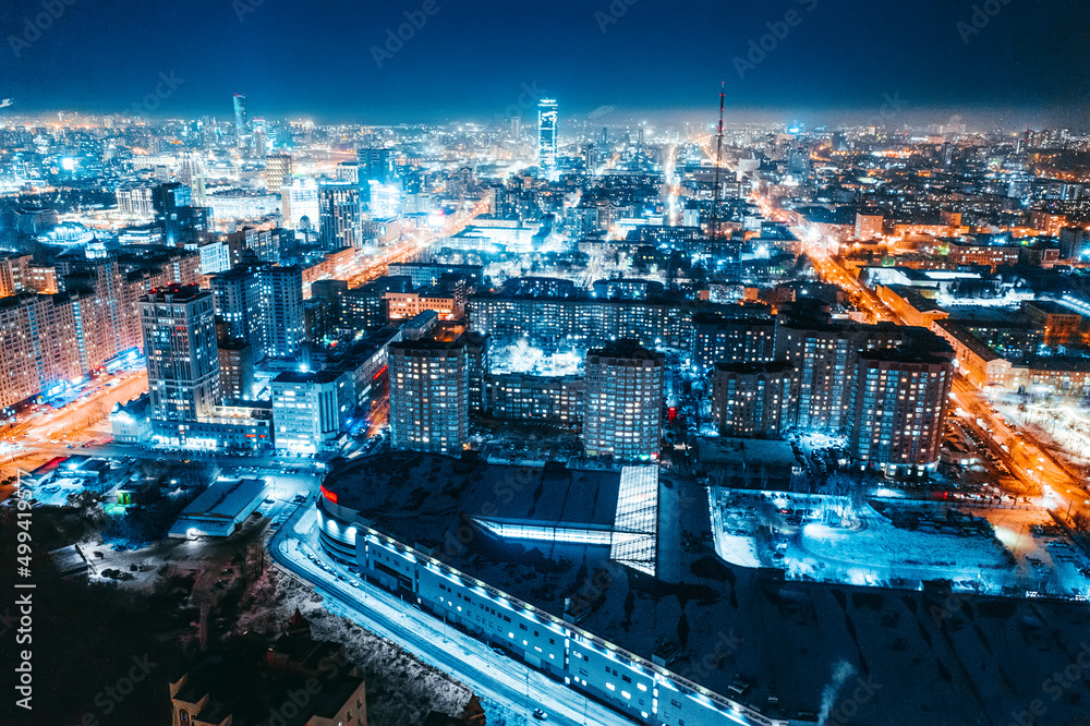Aerial view of the night modern city. Bright lights of the night streets