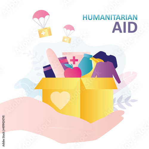 Activist hand holding box of essential food for refugees. Humanitarian aid for migrants and people in difficult life situations