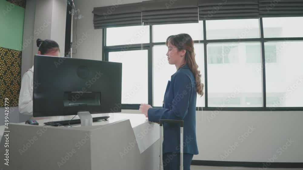 Asian Businesswoman traveling and doing check-in at the airport...Women at the counter taking passport for verification. business travel Asian Businesswoman traveling and doing check-in at the airport...Women at the counter taking passport for verification. business travel
