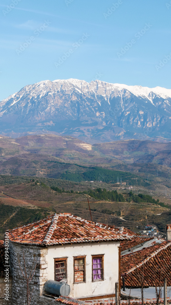 Ruins of Berat, Albania with snow-capped mountains in the background