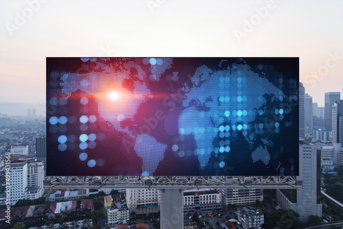 Glowing hologram of Earth planet map on billboard over aerial panoramic cityscape of Kuala Lumpur at sunset, Malaysia, Asia. The concept of international business in KL. © VideoFlow