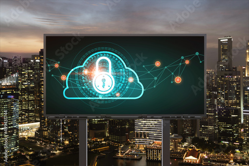 Padlock icon hologram on road billboard over panorama city view of Singapore at night to protect business, Southeast Asia. The concept of information security shields.