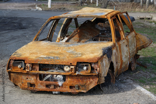 A completely burnt civilian vehicle in the war in Ukraine. Loss of civilians. Car after the fire. © Pro Photo Factory