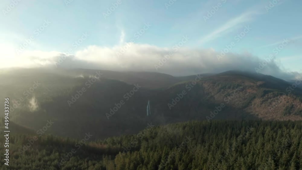 Aerial video of panoramic view of Powerscourt waterfall, sunshine and cloud, light fog over the forest Aerial video of panoramic view of Powerscourt waterfall, sunshine and cloud, light fog over the forest