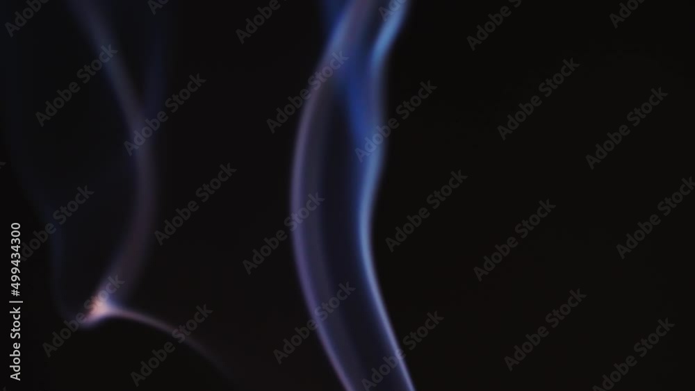 Abstract blue color smoke with a black background in slow motion. Realistic cloud smoke with a streamlined pattern. Abstract blue color smoke with a black background in slow motion. Realistic cloud smoke with a streamlined pattern.