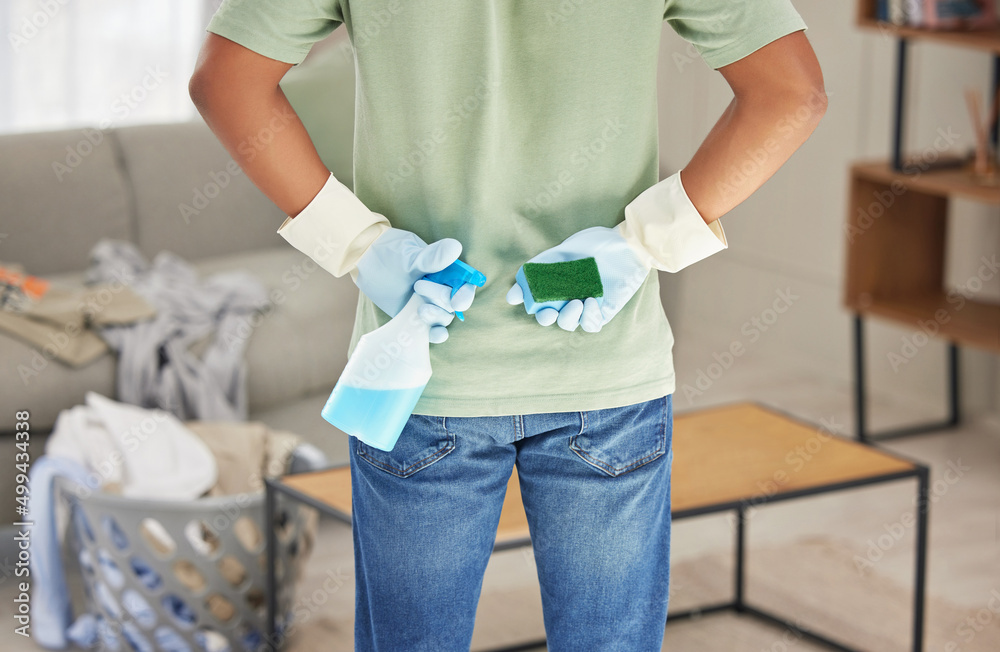 Ready to tackle the dirt. Shot of a man holding a bottle of detergent and sponge ready to clean his home.