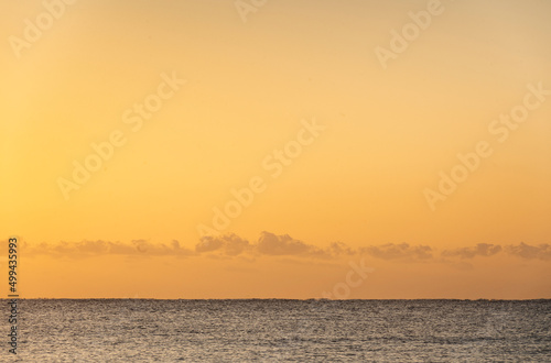 Calm sea and gold sky at sunset