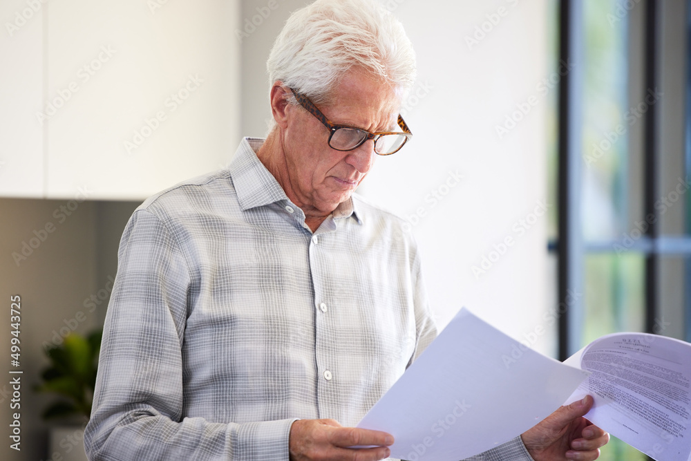 I see a few details I want to change. Shot of a mature man reading paperwork. I see a few details I want to change. Shot of a mature man reading paperwork.