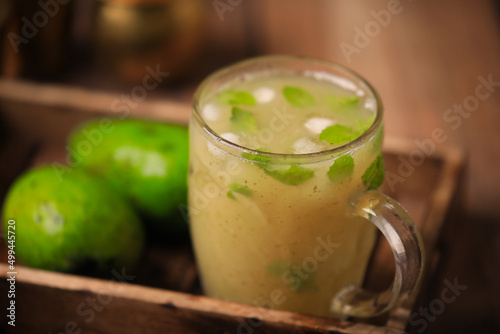 Aam ka panna refreshing summer cooler popular in northern and western parts of India ,summer cooler made from unripe green mangoes closeup with selective focus and blur photo