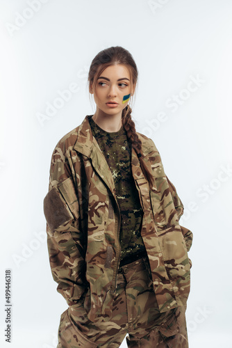 Girl in military uniform. Ukrainian. flag of Ukraine on the face. War in Ukraine. Bucha. on a white background