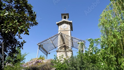 Static shot of Old Clock Tower of Georges Brassens Public Park located in the 15th arrondissement of Paris, France.