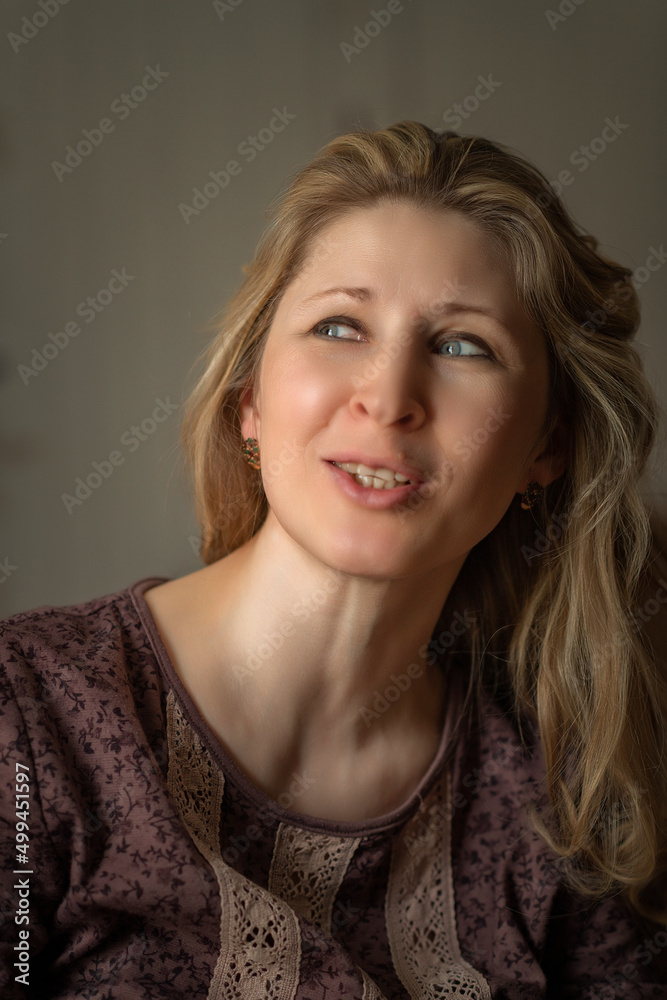 Close-up portrait of a beautiful fair-haired middle-aged woman. Close-up portrait of a beautiful fair-haired middle-aged woman.