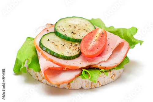 Light Breakfast. Quick and Healthy Sandwich. Rice Cake with Ham, Tomato, Fresh Cucumber and Green Salad - Isolated on White