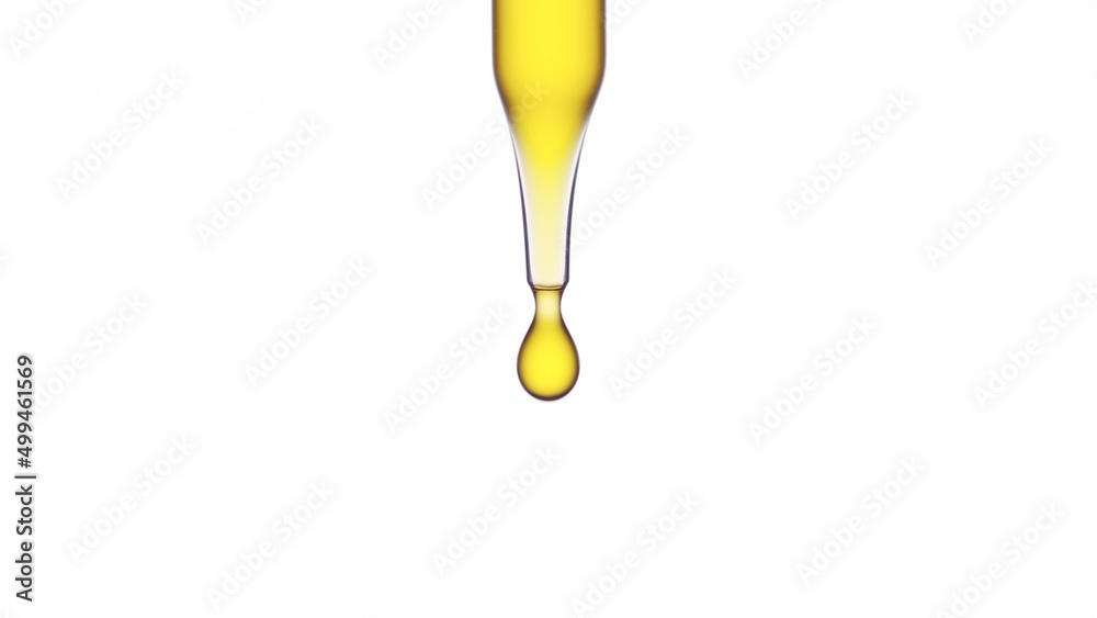 Macro shot of yellow drop is dripping from lab dropper against white background | Abstract skin care cosmetic ingredients formulating concept Macro shot of yellow drop is dripping from lab dropper against white background | Abstract skin care cosmetic ingredients formulating concept