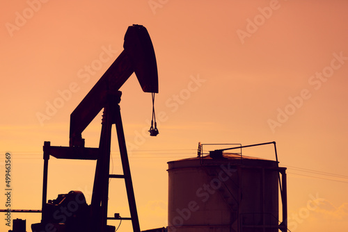 Backlit view of an oil well. oil extraction machine photo