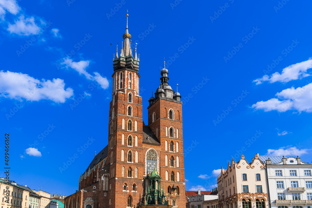 Basilica of Holy Mary on the main market square of krakow sunny day under a blue sky with white clouds