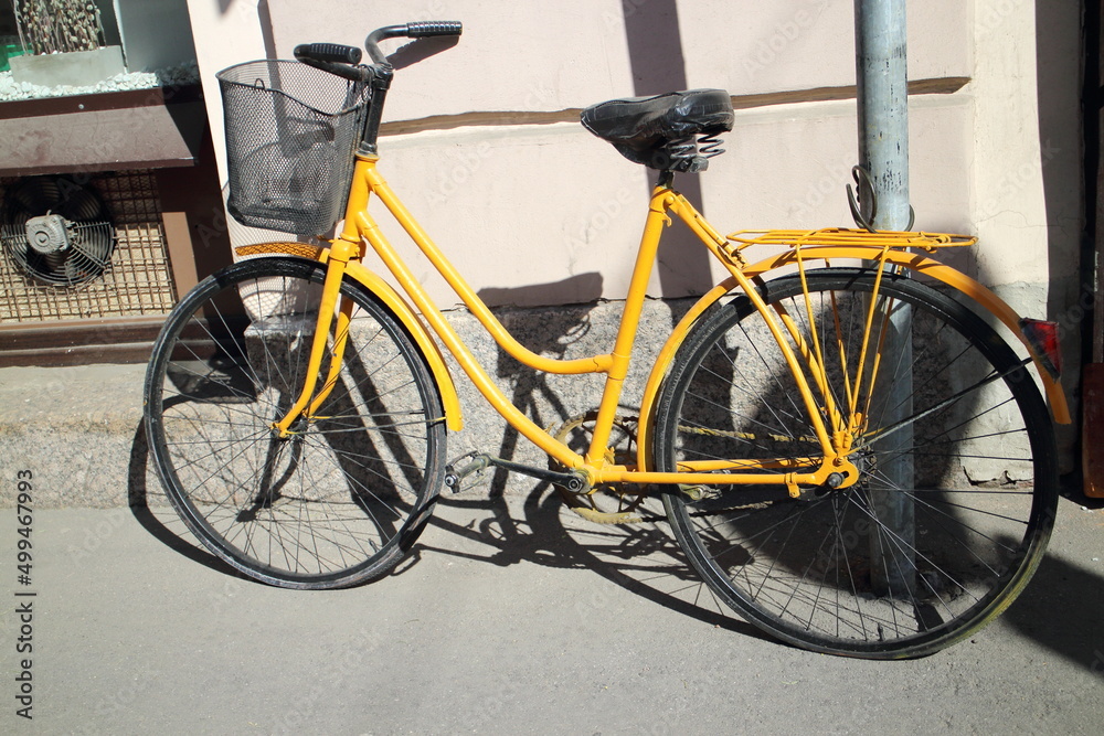 Bicycle stands against the wall in the city