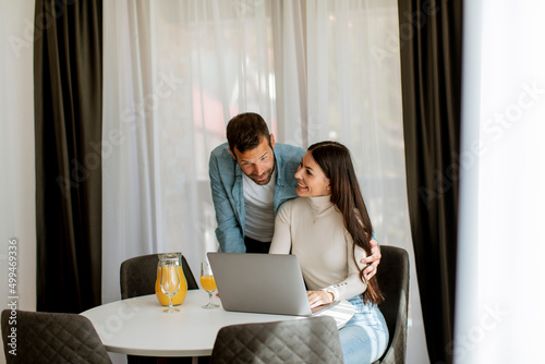 Young couple using laptop c...