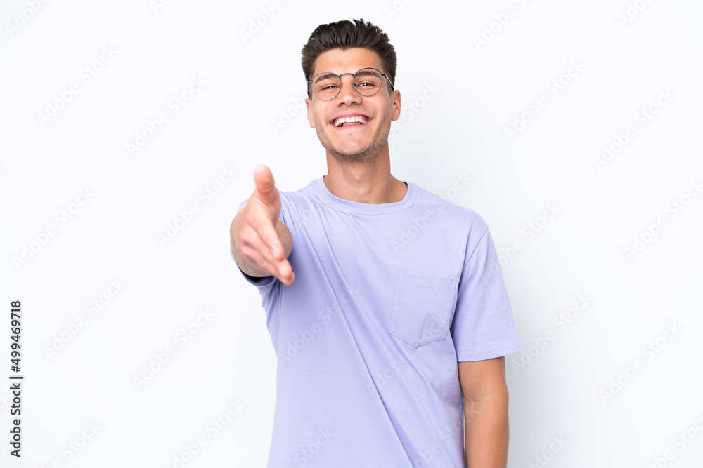 Young caucasian man isolated on white background shaking hands for closing a good deal Young caucasian man isolated on white background shaking hands for closing a good deal