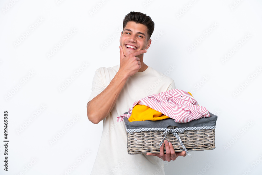 Young caucasian man holding laundry basket isolated on white background happy and smiling Young caucasian man holding laundry basket isolated on white background happy and smiling