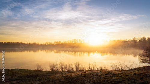 Sunrise at the Illingen quarry pond on a cold foggy morning