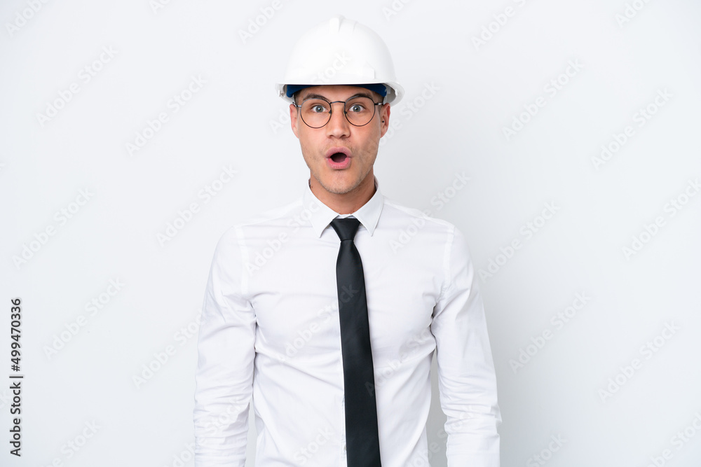 Young architect caucasian man with helmet and holding blueprints isolated on white background with surprise facial expression Young architect caucasian man with helmet and holding blueprints isolated on white background with surprise facial expression