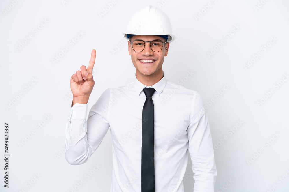 Young architect caucasian man with helmet and holding blueprints isolated on white background showing and lifting a finger in sign of the best Young architect caucasian man with helmet and holding blueprints isolated on white background showing and lifting a finger in sign of the best