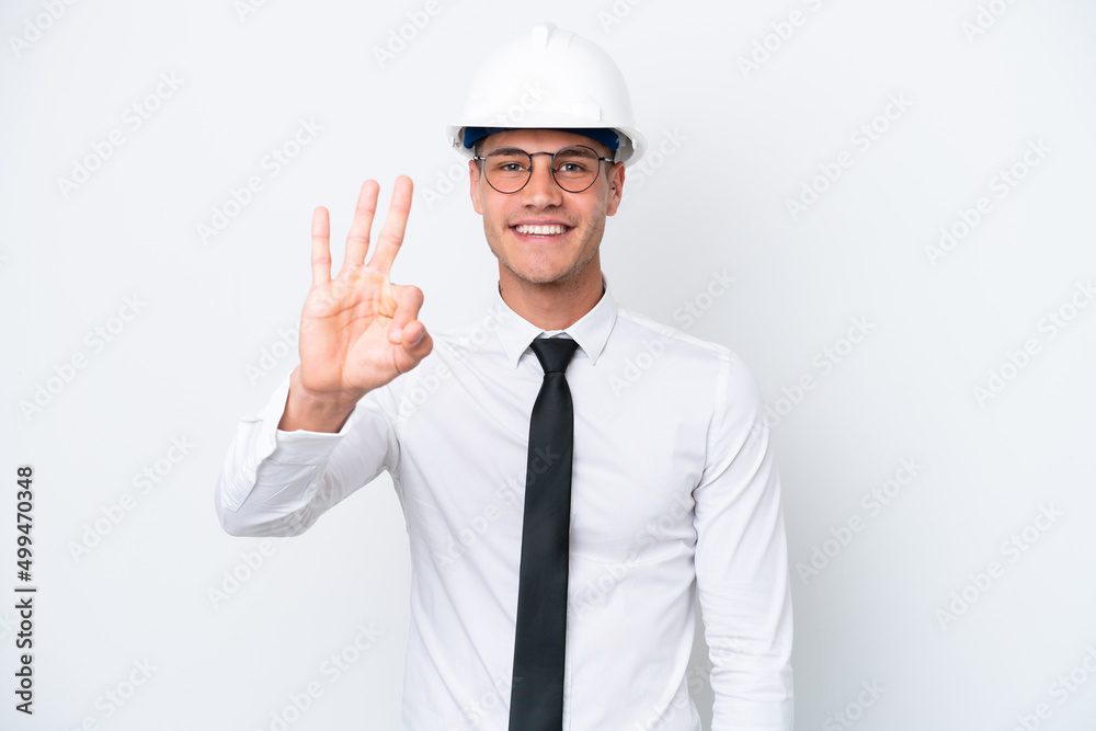 Young architect caucasian man with helmet and holding blueprints isolated on white background happy and counting three with fingers Young architect caucasian man with helmet and holding blueprints isolated on white background happy and counting three with fingers