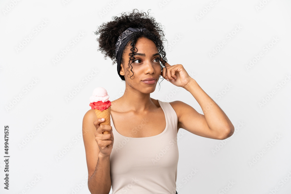 Young african american woman with a cornet ice cream isolated on white background having doubts and thinking Young african american woman with a cornet ice cream isolated on white background having doubts and thinking