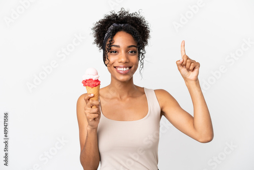 Young african american woman with a cornet ice cream isolated on white background pointing up a great idea