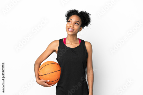 Young basketball player latin woman isolated on white background thinking an idea while looking up