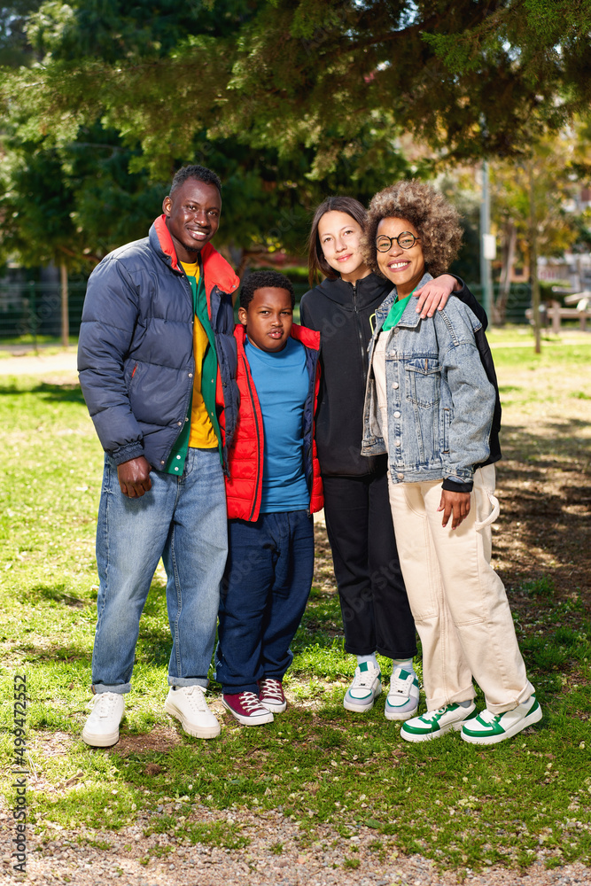 Obraz premium Portrait of happy family father, mother and their son and daughter smiling and looking at camera