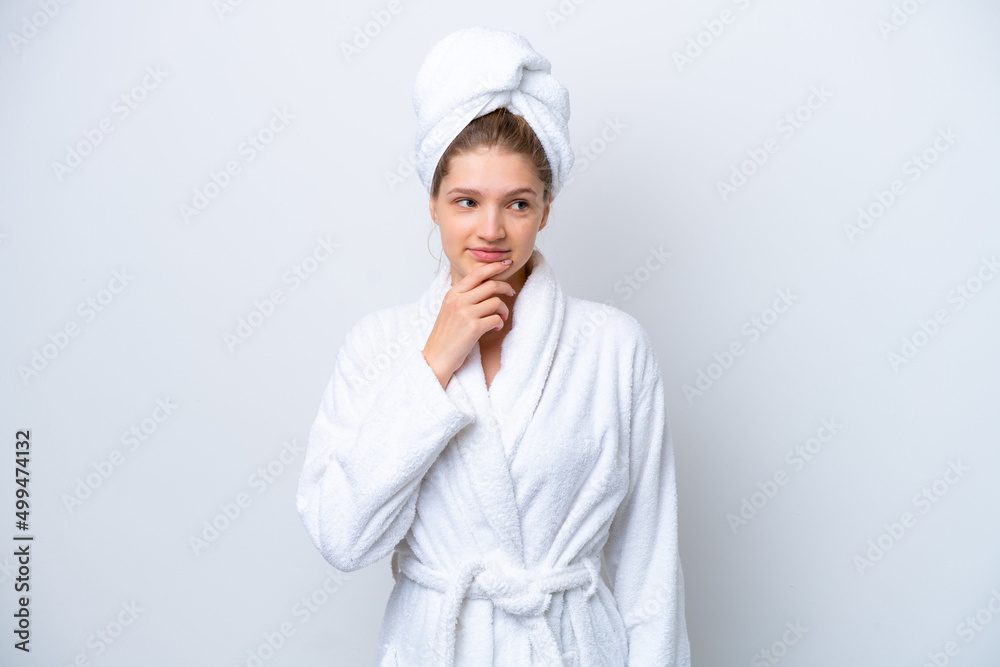 Teenager Russian girl in a bathrobe isolated on white background and looking up Teenager Russian girl in a bathrobe isolated on white background and looking up