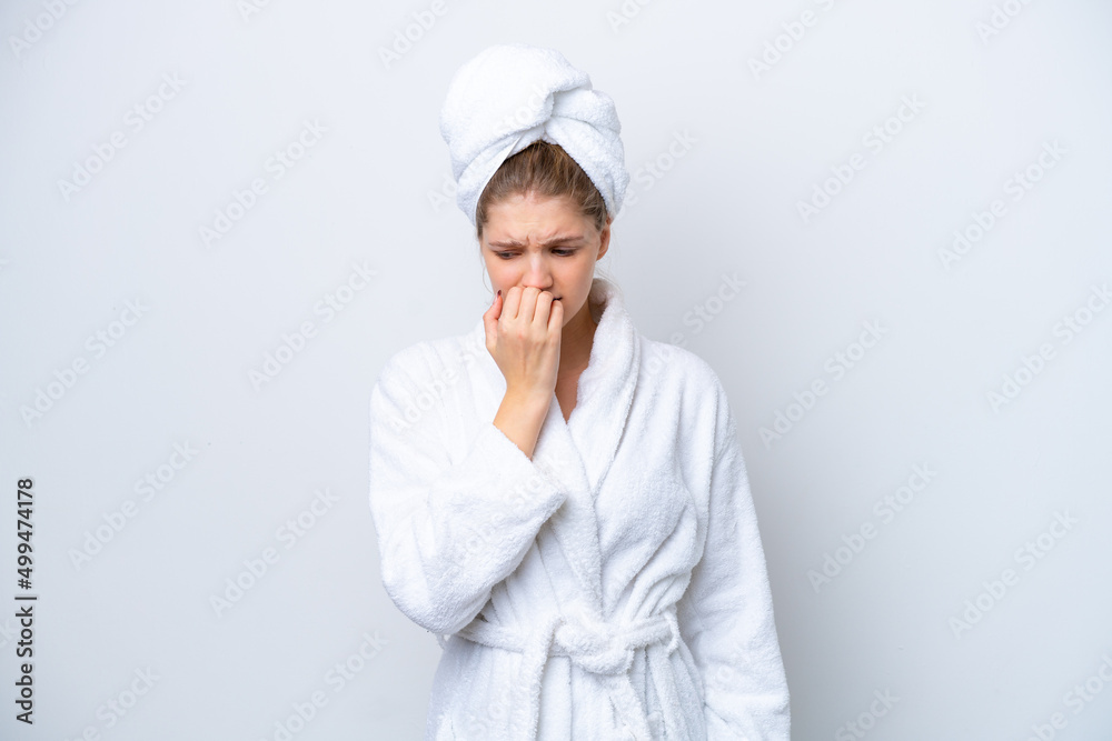 Teenager Russian girl in a bathrobe isolated on white background having doubts Teenager Russian girl in a bathrobe isolated on white background having doubts