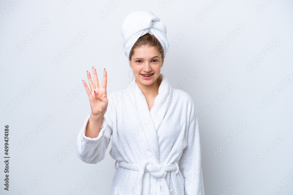 Teenager Russian girl in a bathrobe isolated on white background happy and counting four with fingers Teenager Russian girl in a bathrobe isolated on white background happy and counting four with fingers