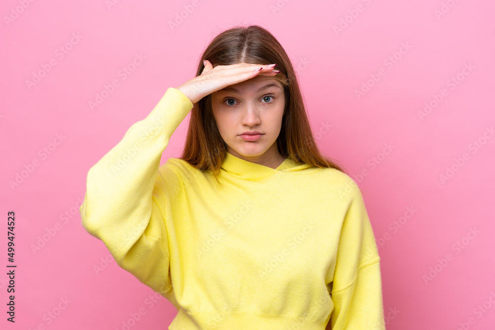 Teenager Russian girl isolated on pink background looking far away with hand to look something Teenager Russian girl isolated on pink background looking far away with hand to look something