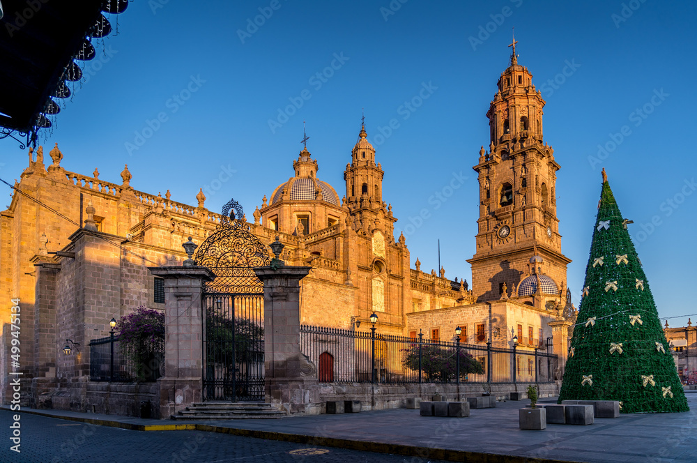 Morelia Cathedral with bright morning sunshire in the city of Morelia, Michoacan, Mexico.