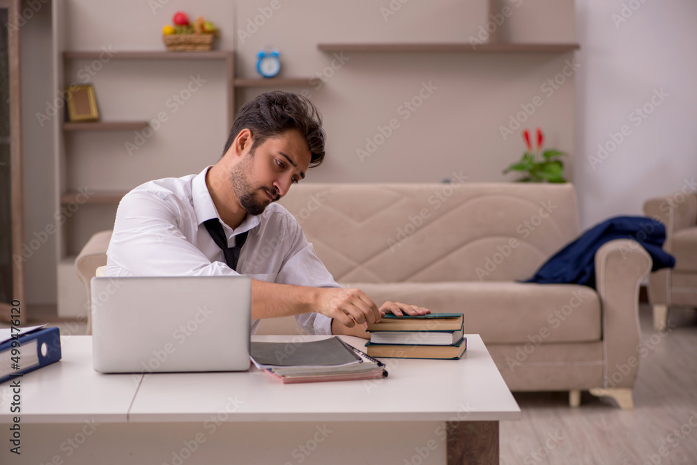 Fototapeta premium Young male employee working from home during pandemic